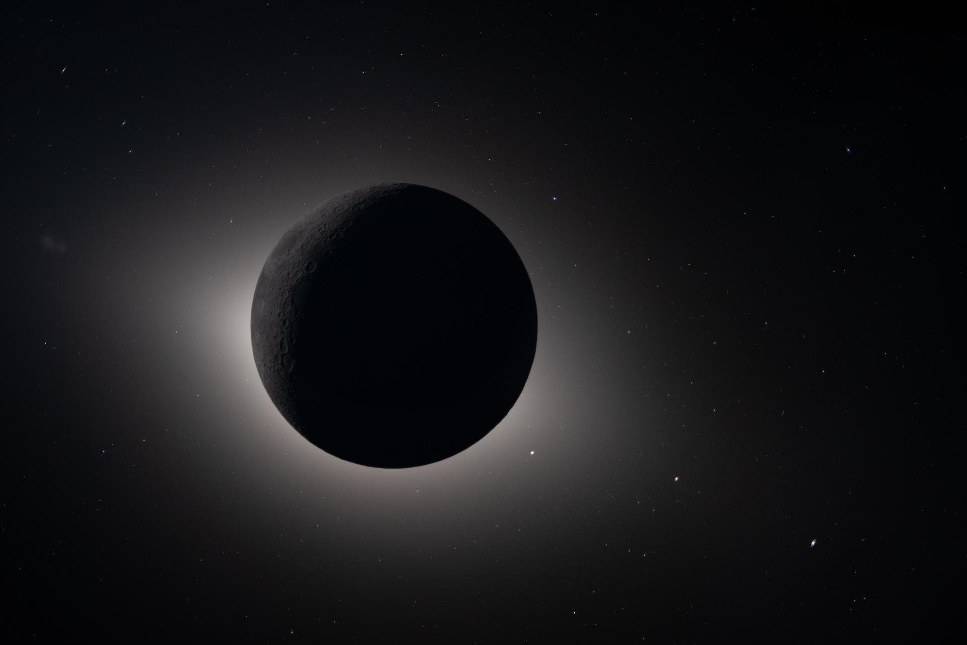 Artemis II eclipse view with the Moon fully obscuring the Sun, a bright halo around the lunar disk, and stars visible in deep space — April 6, 2026