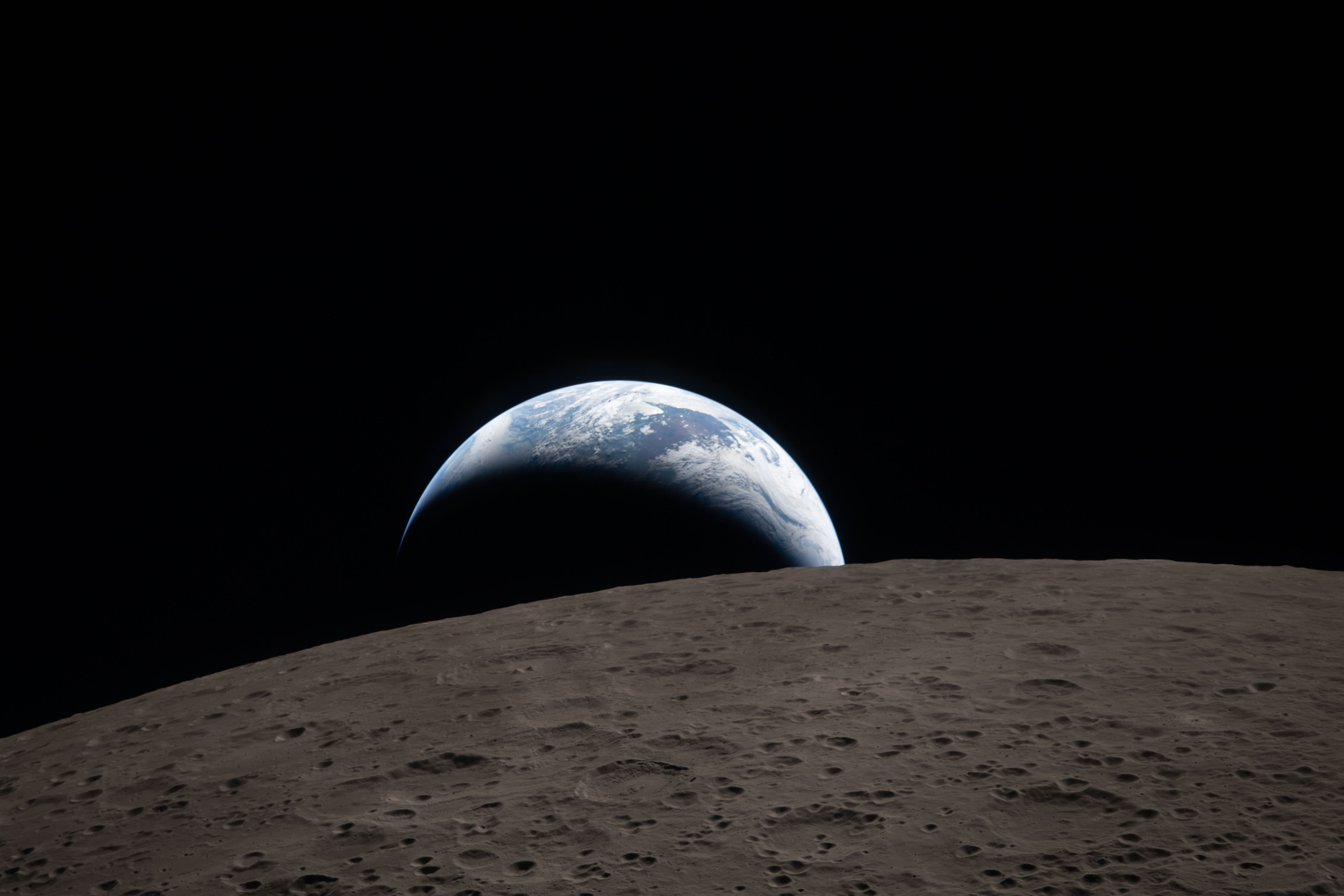 Earth setting behind the lunar limb, photographed by the Artemis II crew on April 6, 2026 — the modern counterpart to Apollo 8's Earthrise